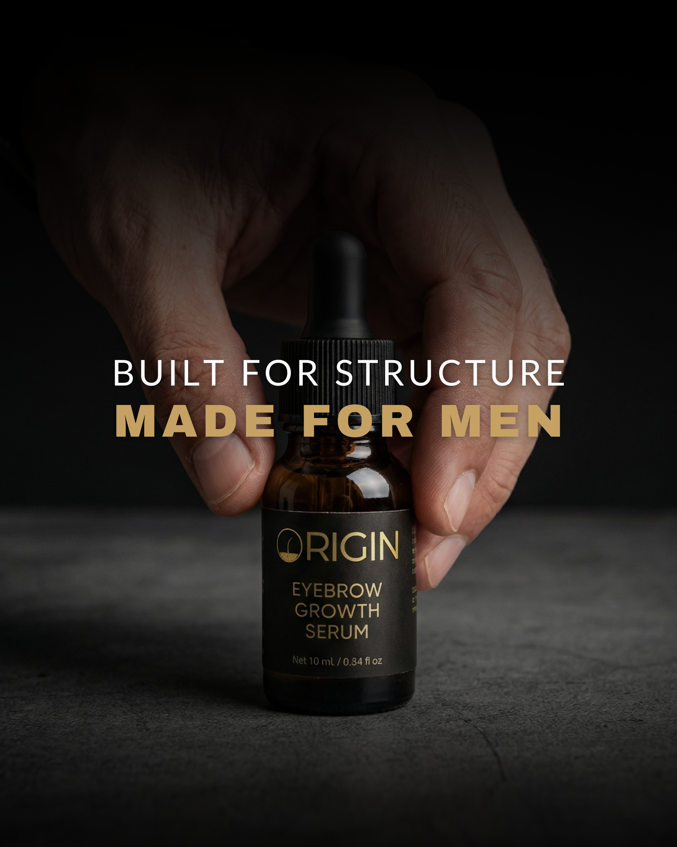 Bottle of Origin Eyebrow Growth Serum held by a hand with text 'Built for structure, made for men' on a dark background.